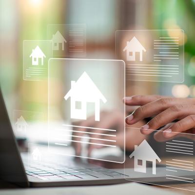 Digital real estate listing graphics over an agent using a laptop.
