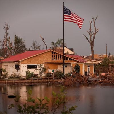 A new American flag pole standing outside a damaged Forest Lake house after the 2011's EF4 tornado in Tuscaloosa, Alabama.