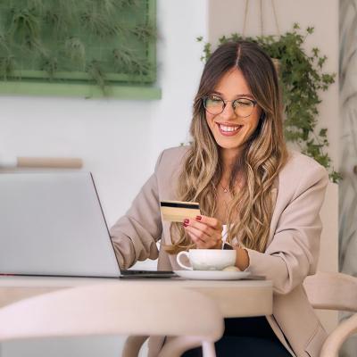 A businesswoman making digital payments with her credit card.