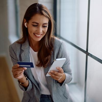 A female entrepreneur paying an online purchase with a credit card.