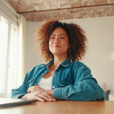 A young adult working remotely from her cozy home workspace.