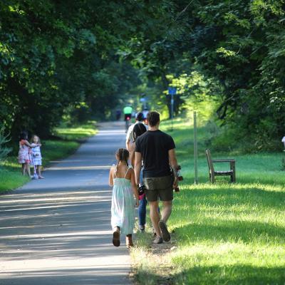 People walking and sitting along Minuteman Bikeway, Massachusetts, USA.