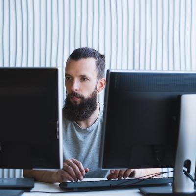 A software engineer working on a quality assurance task in an office.
