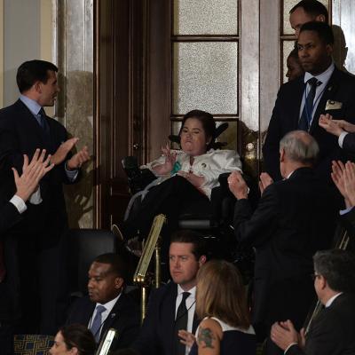 Megan Crowley (C), a Pompe Disease patient, applauded as US President Donald Trump addresses a joint session of the US Congress on February 28, 2017 at the Capitol in Washington, DC. 