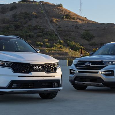 Ford Explorer and Kia Sorento cars parked outdoors.