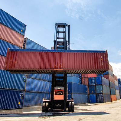 A cargo container being lifted in a shipping yard.
