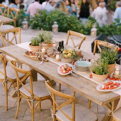 Decorated tables arranged for a rustic wedding dinner.