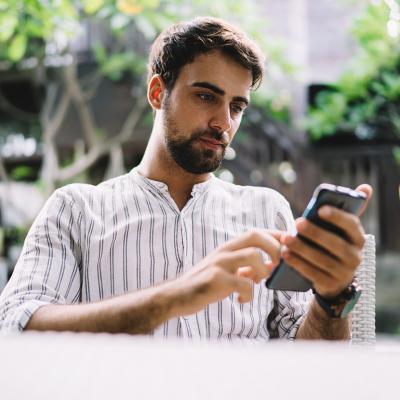 A young businessman browsing information on his phone.