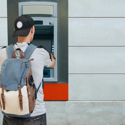 A tourist withdraws from an ATM.