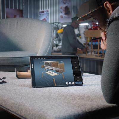 A designer creating a 3D model of a wooden bedside table through a AI software for furniture design.
