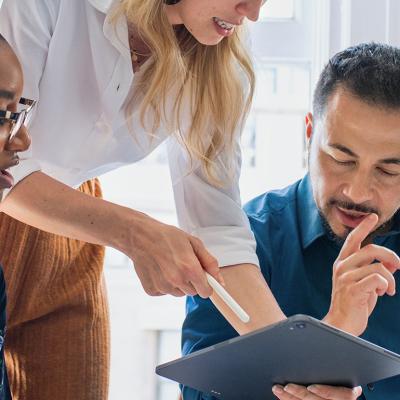 A team of colleagues collaborating for a work project in an office.