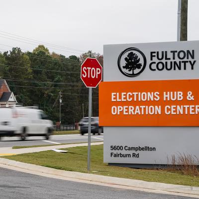 Vehicles pass by the sign for the Fulton County Elections Hub and Operations Center on November 4, 2024, in Union City, Georgia. 