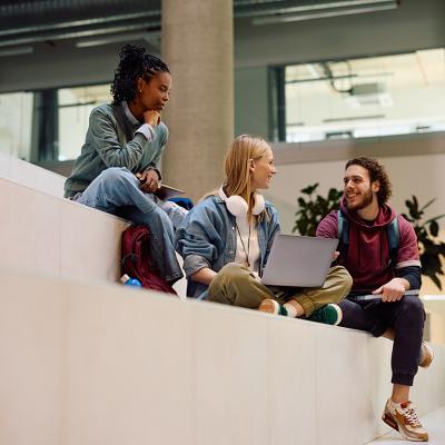 A diverse group of university students having a discussion in campus.
