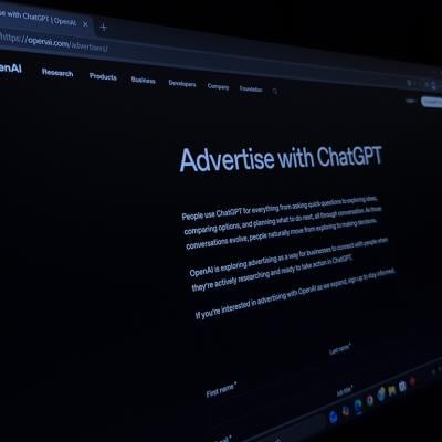Close up image of the official OpenAI webpage displaying the option to "Advertise With ChatGPT".