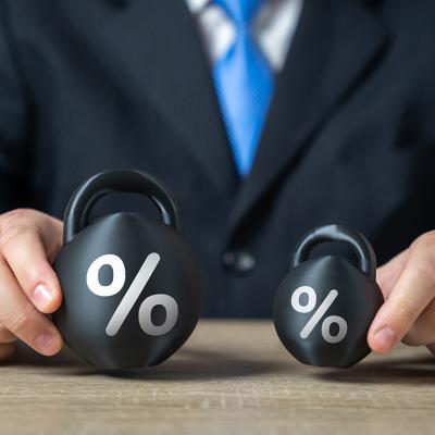 Businessman holding two weights side by side as a concept of concept of debt burden.