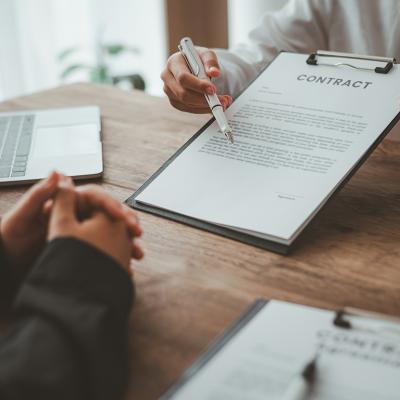 A business partner explaining agreements and matters from a contract to her co-partner.