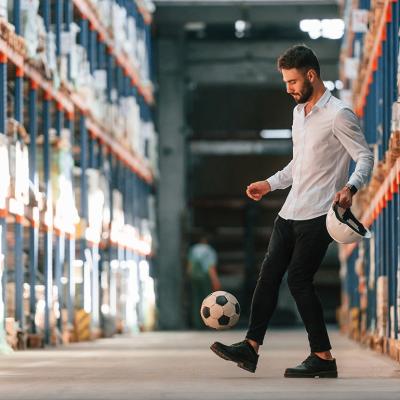 A storage working kicking a soccer ball.