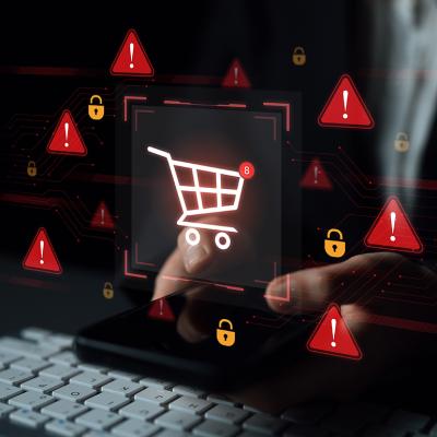 E-commerce security alert graphics over a person typing on a keyboard while shopping online.