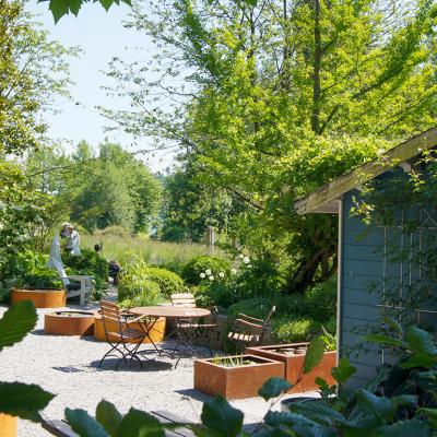 A lovely garden space with outdoor seating area and a garden shed.