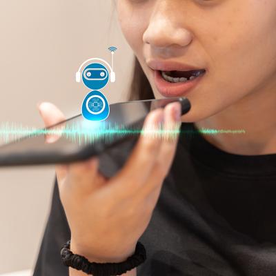 A young woman talking into a smartphone with AI voice assistance.