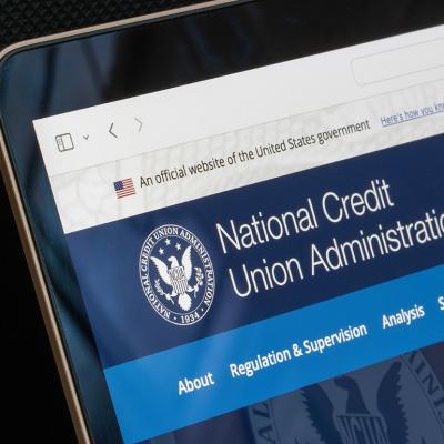 A website homepage of the United States' National Credit Union Administration displayed from a laptop screen.