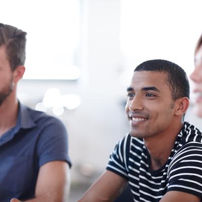 Office employees listening during a workshop session about team development in the workplace.