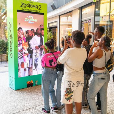 Young people in front of an interactive Zootopia 2 promotional activation kiosk at Westfield Century City.