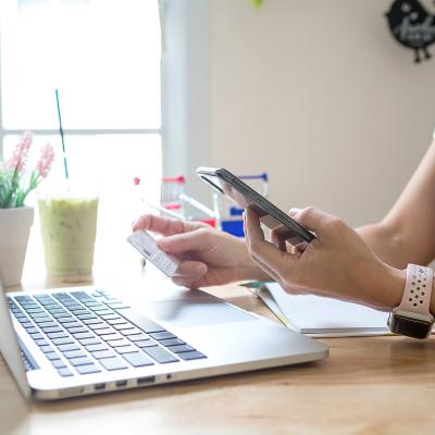 A person checking her credit card's details for a digital transaction from online shopping.