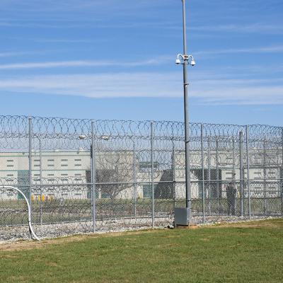 A fence, barbed wire and a guard are visible at the Allan B. Polunsky Unit, the prison that houses the 169 men on Texas' death row in Livingston, Texas.