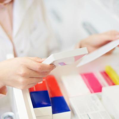 A pharmacist filling prescription at a pharmacy.