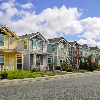 A row of colorful family homes in a residential neighborhood.