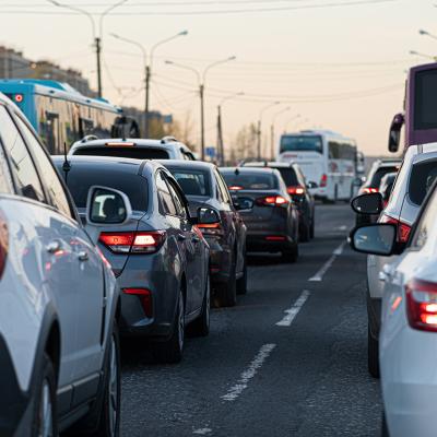 Traffic jamming during rush hour in the city neighborhood at early evening.