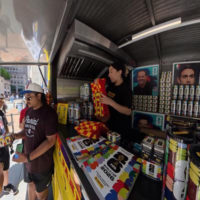 Sports fans buying World Cup stickers at a vending cart in New York City, USA.