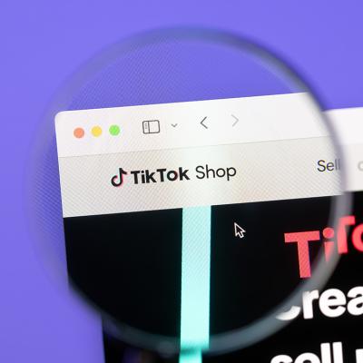 A focused shot of Tiktok Shop brand's webpage through magnified lens.