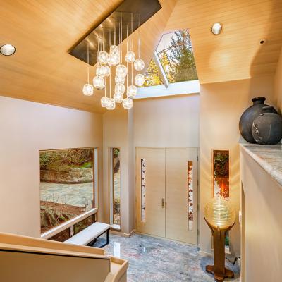 A grand entry foyer of a luxury home with multi-glass ball chandelier.