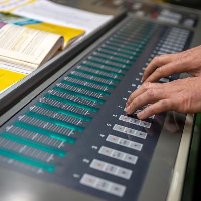 An operator working on an off-set printing machine.