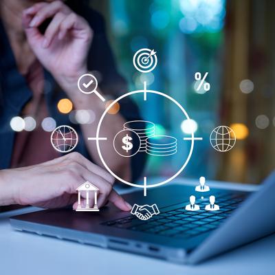 A businessman using a laptop illustrated with investment banking graphics.