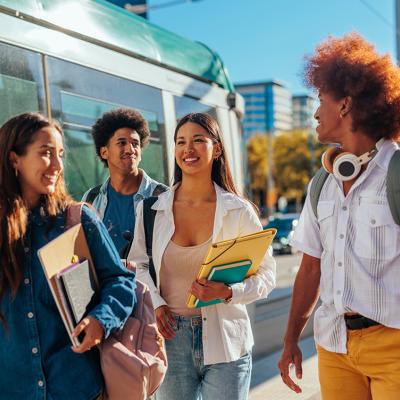 A group of students catching the train to home from school.