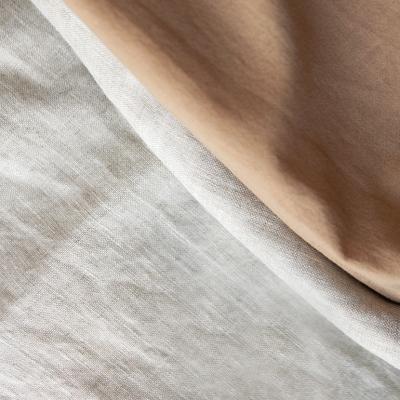 Folded linen cloths spread in a textured background.