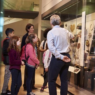 Students looking through artifacts during a museum visit. 