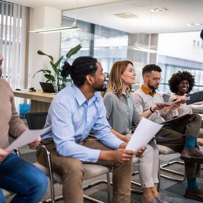 Corporate applicants waiting for a job interview in an office's lobby.