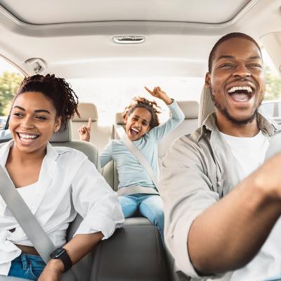 A happy family enjoying a summer road trip.