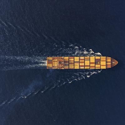 Aerial view of a large cargo ship traveling at sea.