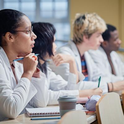 A class of medical students attentively listening to a lecture.