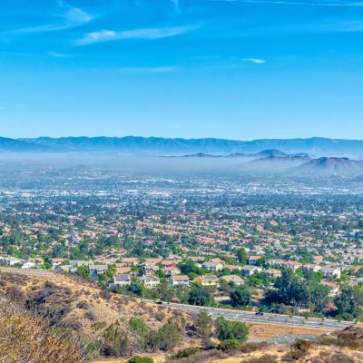 Aerial view of inland California featuring a view of residential homes and hills.
