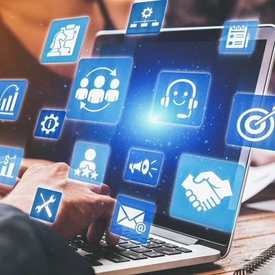 A business analyst managing CRM platforms from a laptop to improve customer relationships through data analysis.