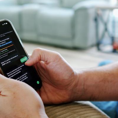 An automated scam text message displayed from a person's smartphone.