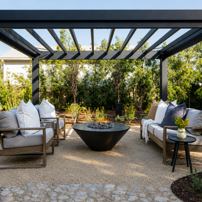 A modern black aluminum pergola structure with a contemporary outdoor lounge area.