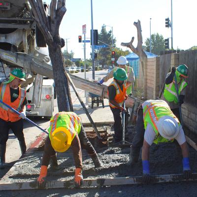 Construction crew doing a sidewalk repair work at day. 