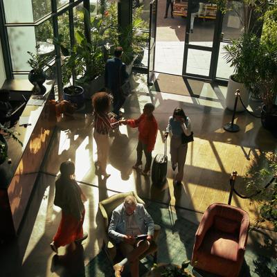 Guests arriving to check in at a hotel lobby.